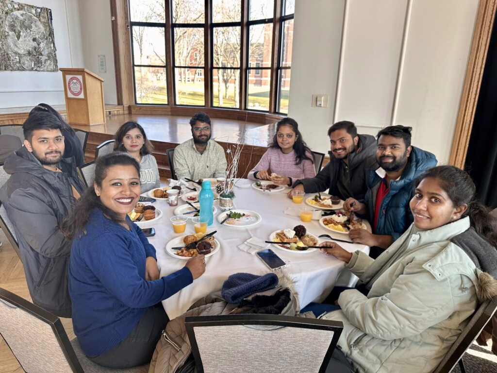 international students sitting around table eating breakfast