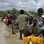 climate fefugees walking in flooded streets