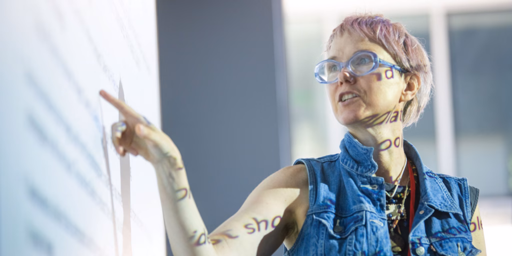 Professor in front of whiteboard in MFA class