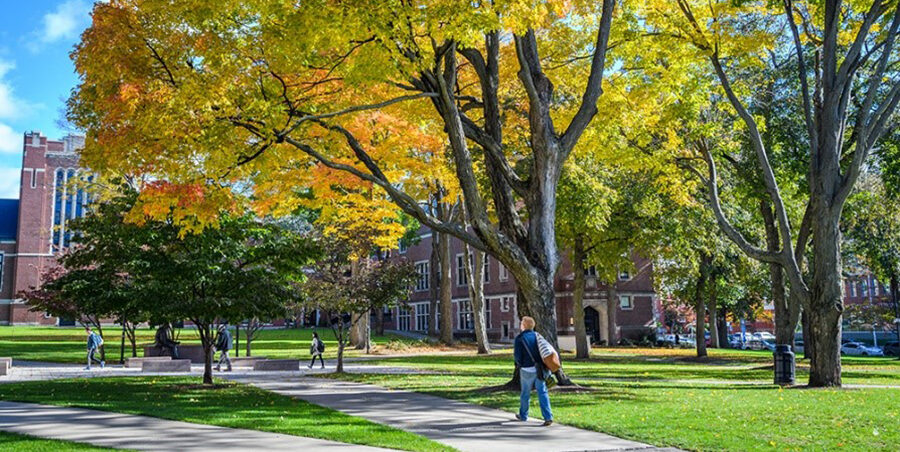 student walking on campus in fall