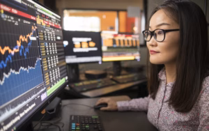A woman analyzes data on screen