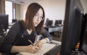 accounting analytics - student behind computer