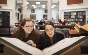 Students looking over newspaper archives