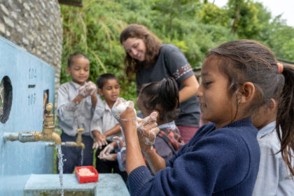 Children learn about sanitation at a handwashing station in Nepal.
