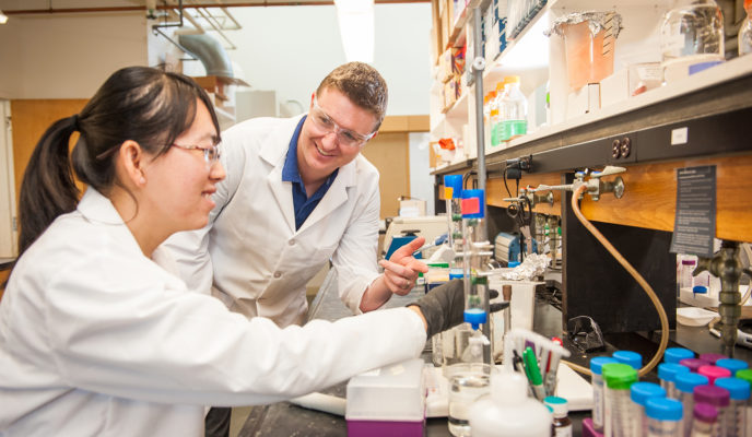 Don Spratt with female student in lab