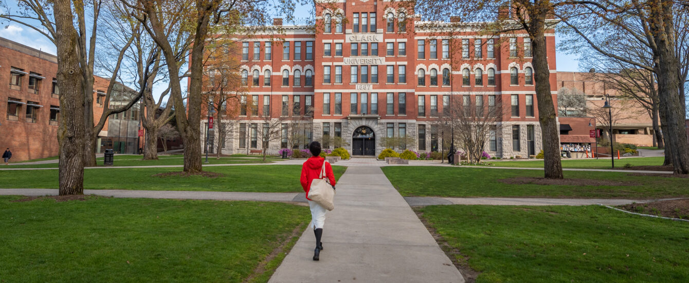 Student walking towards Jonas Clark Hall