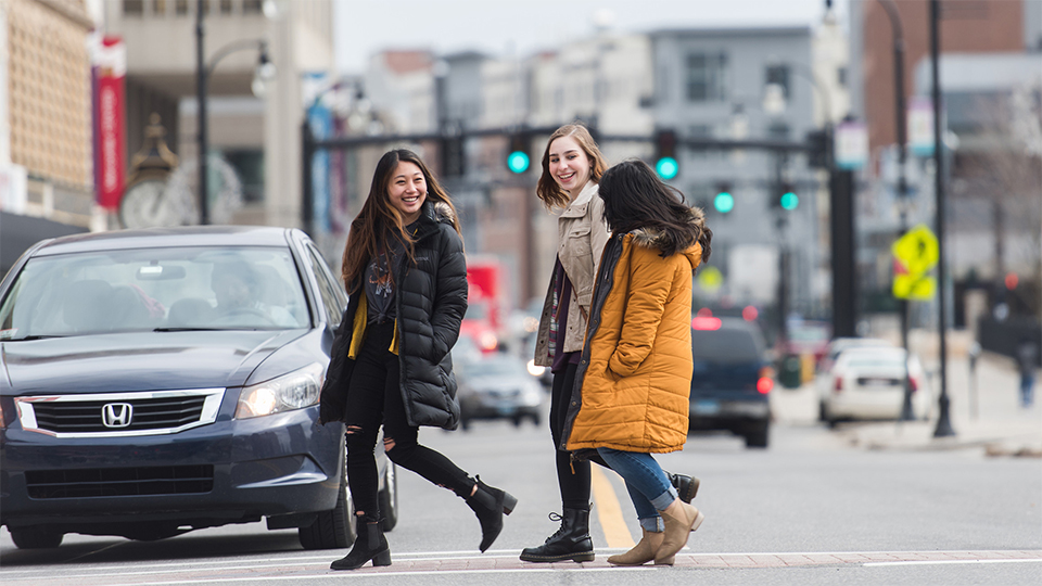 girls walking across street