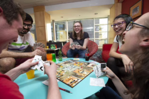 students playing board game with cards