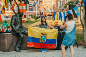 girl holding up hispanic flag