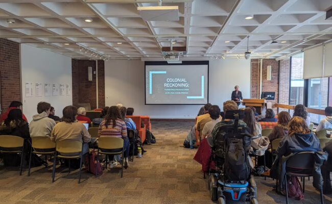 students watching a film on Colonial Reckoning