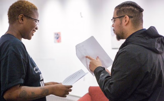 Toby Sisson talking to other student