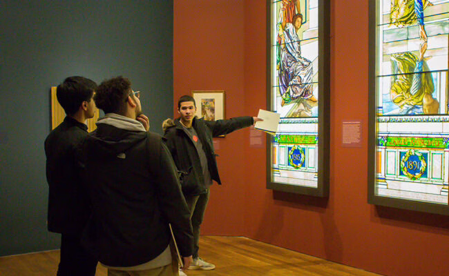 students looking at glass stained pieces