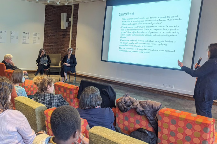 professors with slide show showing audience