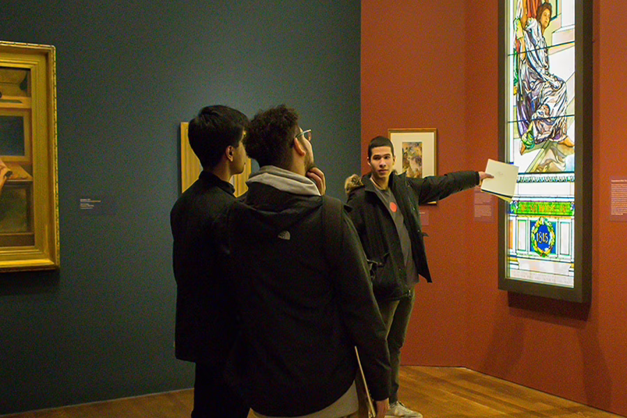 student looking over art work