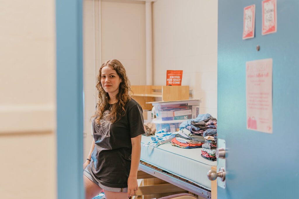 girl in dorm room with supplies