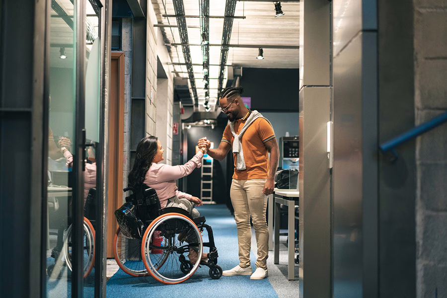 disabled woman shaking hand of a man in server room