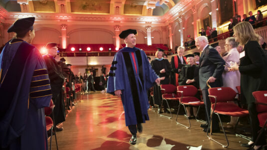 David Fithian walks into the inauguration ceremony in Mechanics Hall