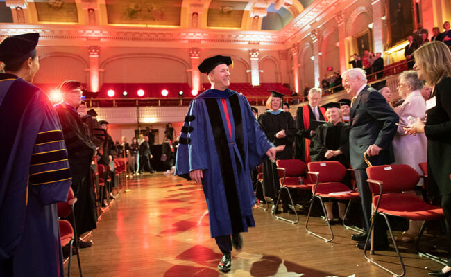 David Fithian 10th Clark President walking down aisle at Mechanics Hall.