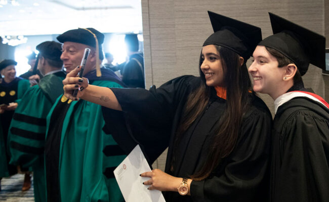 Students taking pictures of themselves at inauguration