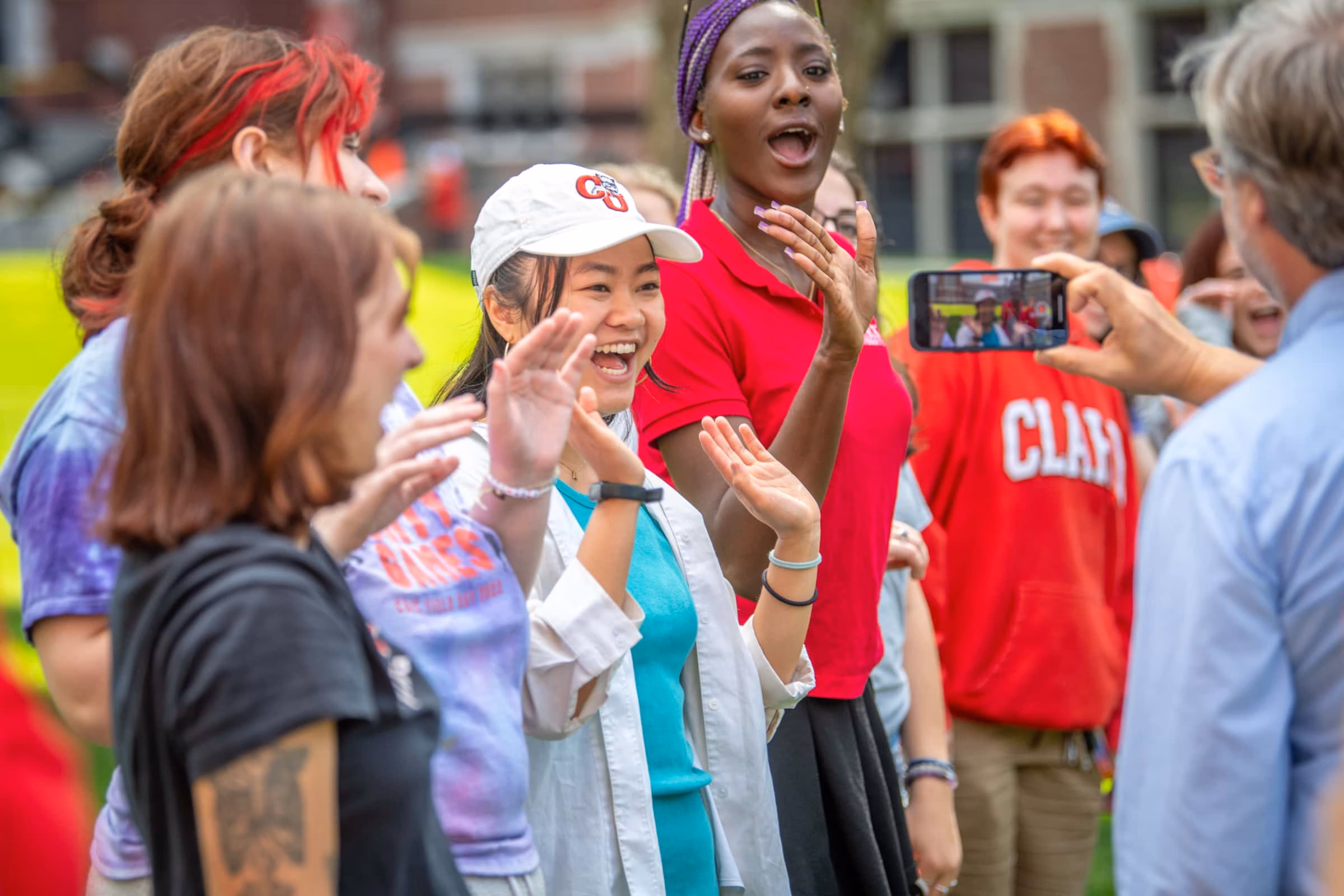 Students wave to greet incoming students on move-in weekend.