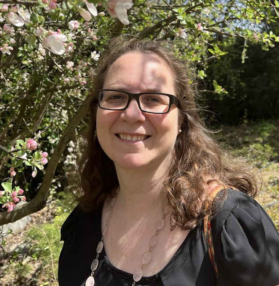 Susan Beth Rottmann standing in front of a tree