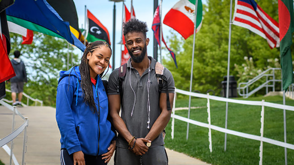 Students in front of world flags