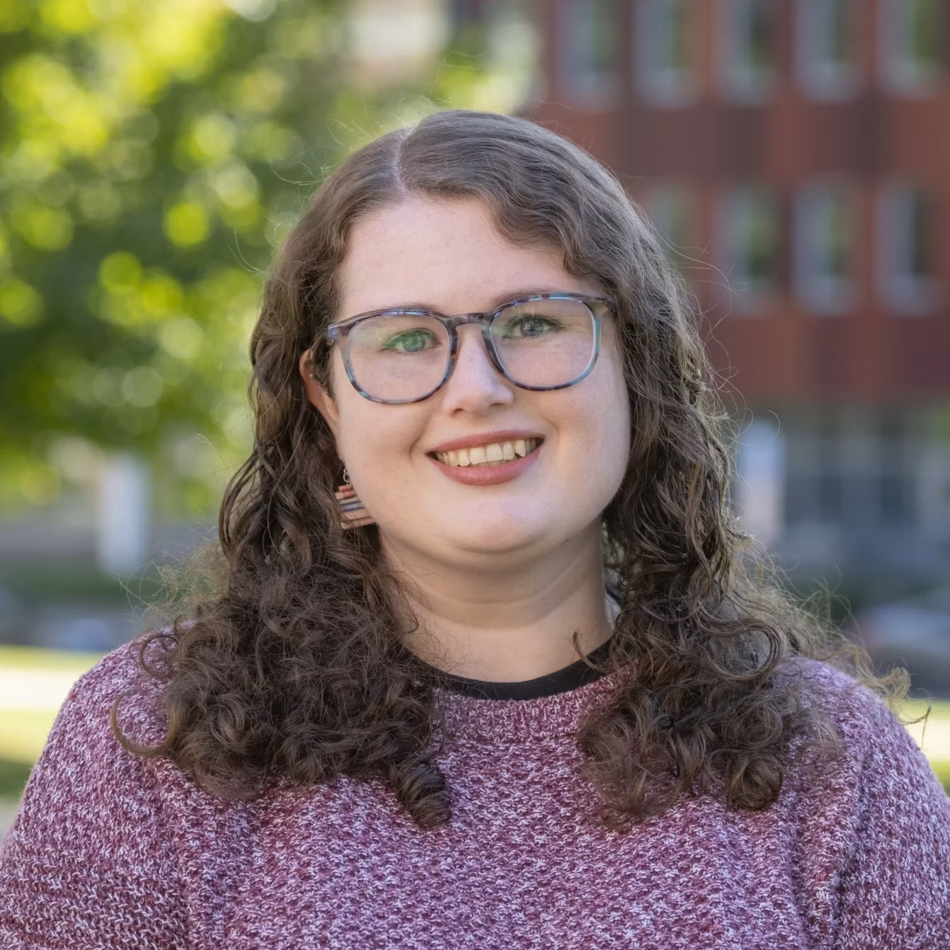 A portrait of Kara Mackie, Access and Outreach Librarian.