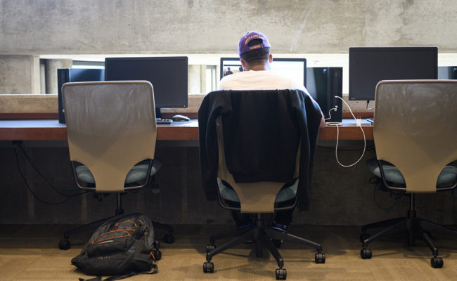 students at desks in library