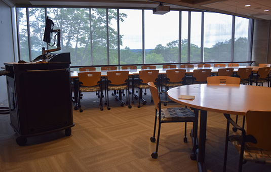 fuller music room with chairs and tables and a podium