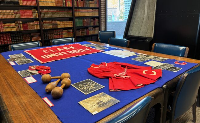 "Vintage Clark" display in the Archives and Special Collections Reading Room. featuring photographs, banners and an original cheerleaders uniform