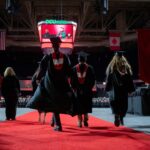 Students, seen from behind process in during Commencement.exercises