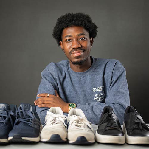 Jordan Adeyemi with donated athletic shoes