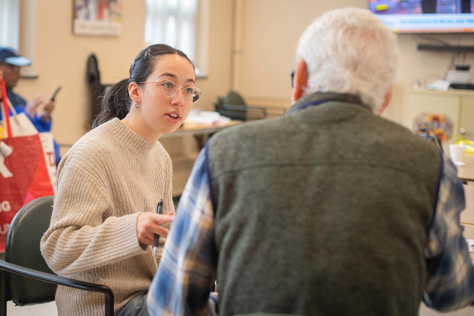 A Clark University student volunteers at a local retirement community.