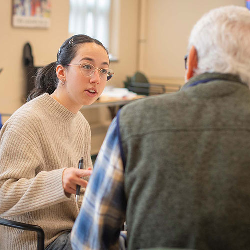 A Clark University student volunteers at a local retirement community.