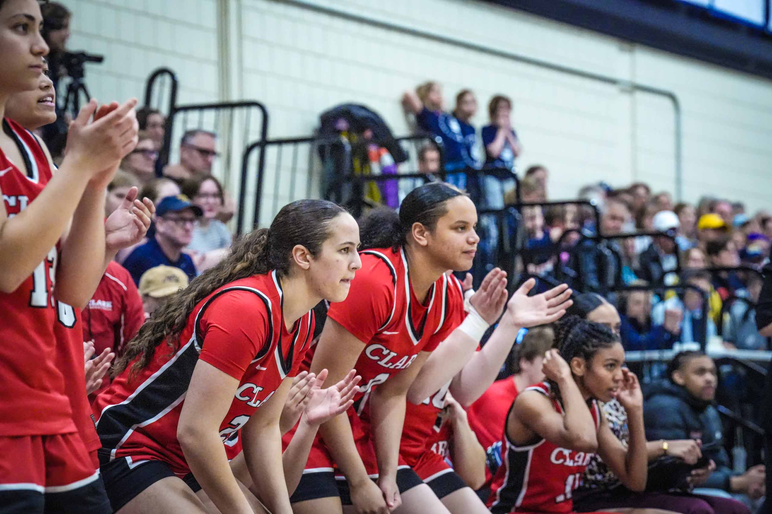 NEWMAC champion women's basketball team cheering for their teammates on the court, 2026