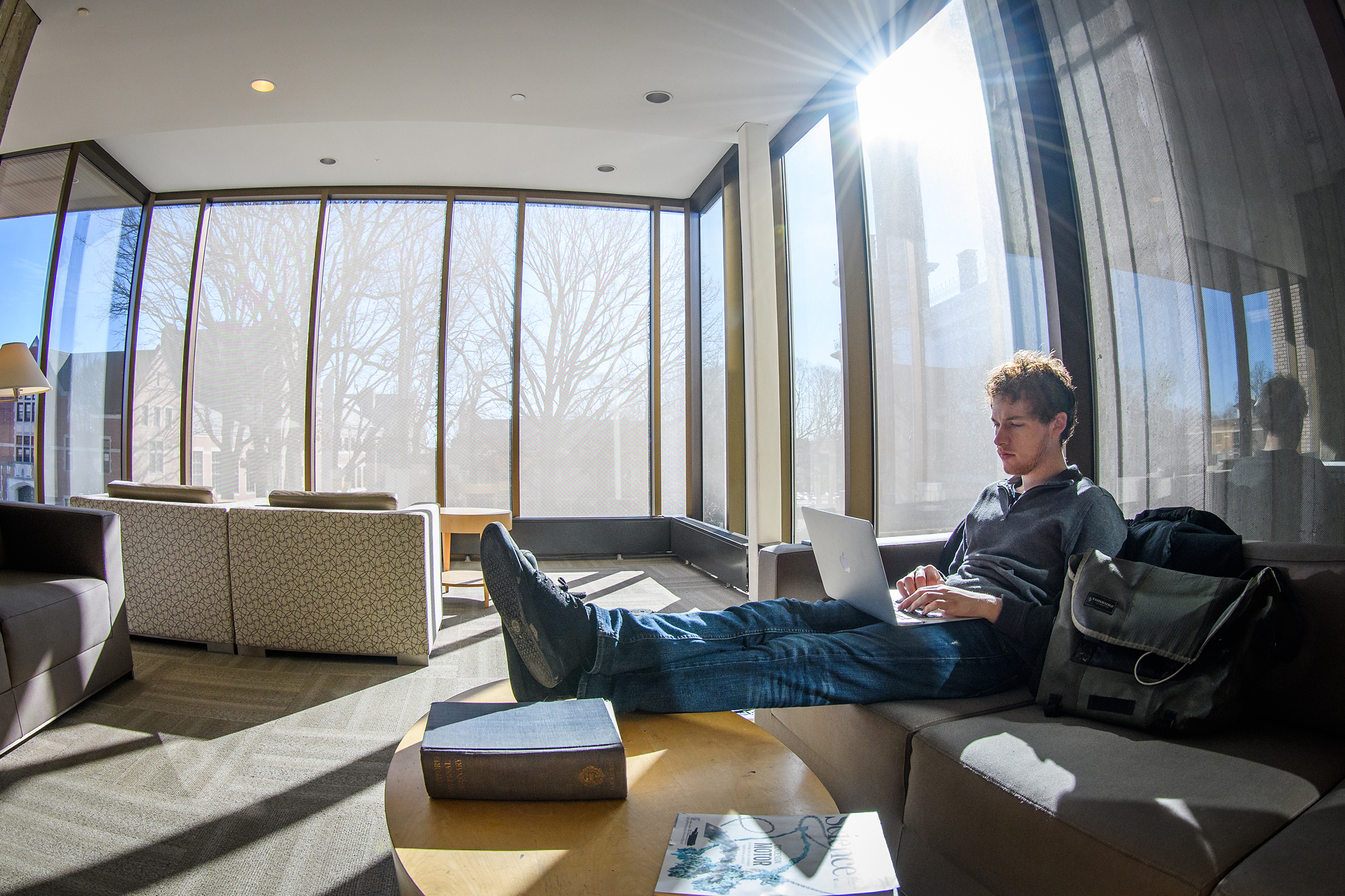 Goddard Library - male student sitting in front of windows