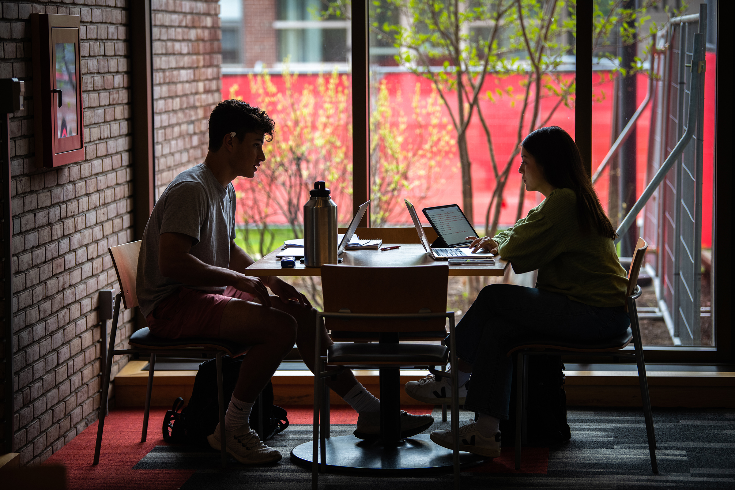 Goddard Library -  two students sitting at table with laptops