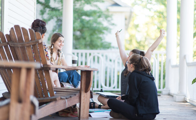 International Development, Community and Environment House -front porch with students