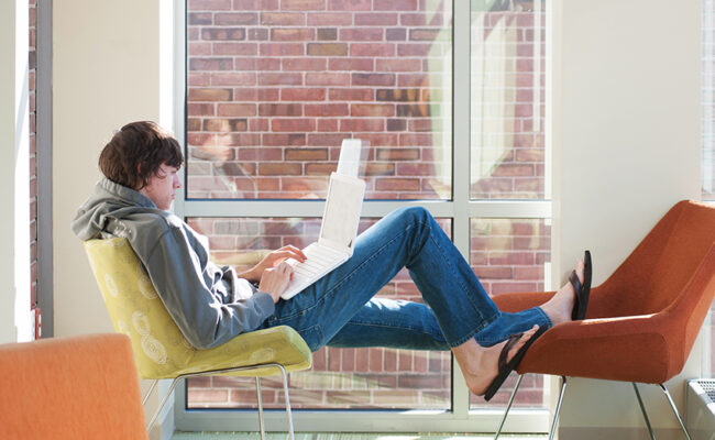 Blackstone Residence Hall - boy sitting in window