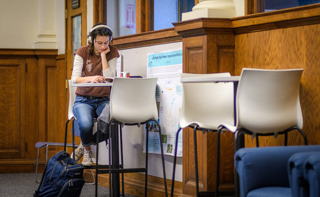 Girl sitting outside an office in hall way