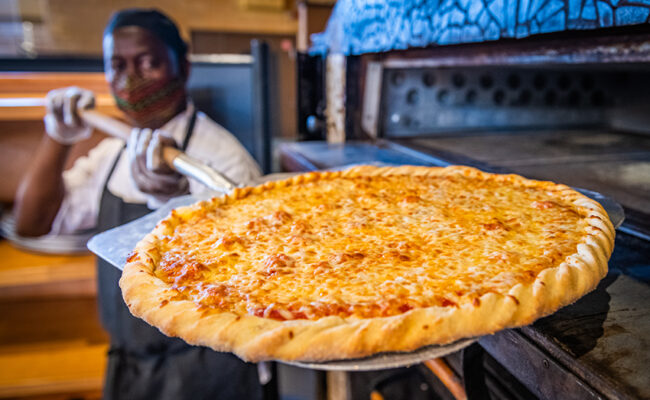 Higgins University Center - cafeteria - man serving pizza