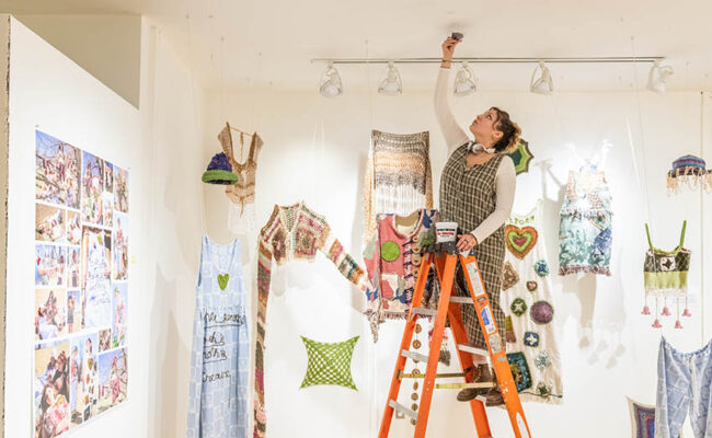 Traina Center for Arts - student is setting up a arts display