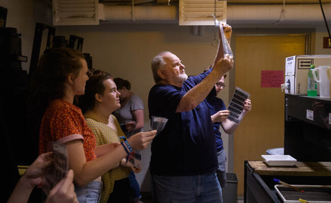 Traina Center for Arts - professor looking at film with students