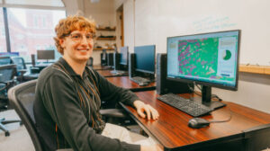 Student Rowan Compton studies land changes on computer screen
