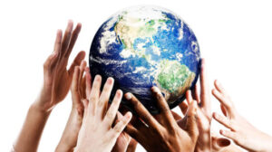 Many mixed hands reaching up to grab a piece of Mother Earth.