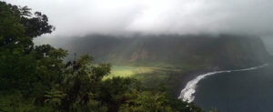Waimea Valley Hawaii Overlook Foggy view of Coast. Heavy cloud cover of fertile utopian paradise valley from top of mountain with mountains in the distance. Fertile Utopian Valley where Kings meet
