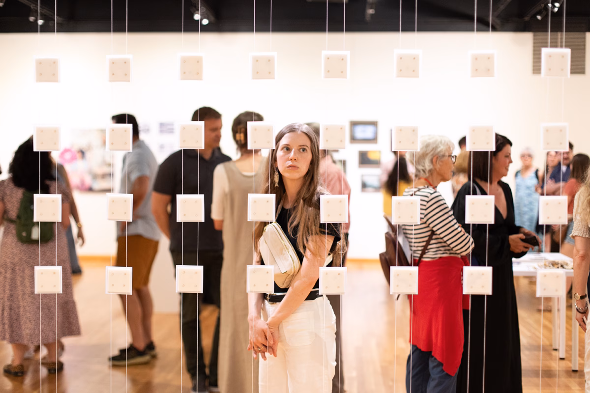 Woman looking at hanging art