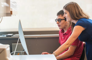 male and female looking at compute