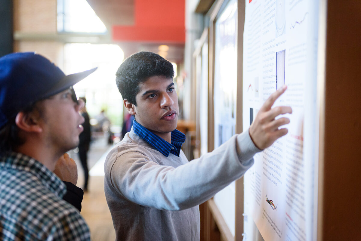 Bernny Ramirez points to poster