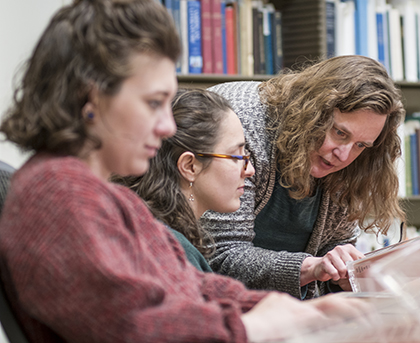Professor Meredith Neuman works with students